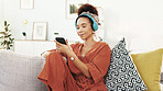 Happy woman, relax and phone with headphones on sofa for music, listening or online streaming at home. Young, female person or user with mobile smartphone for podcast, sound or playlist at house