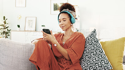 Buy stock photo Happy woman, relax and phone with headphones on sofa for music, listening or online streaming at home. Young, female person or user with mobile smartphone for podcast, sound or playlist at house