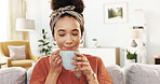 Woman, happy and smell coffee on sofa with thinking, reflection and start morning in home. Girl, person and tea cup with memory, insight and drink with nostalgia on living room couch at apartment