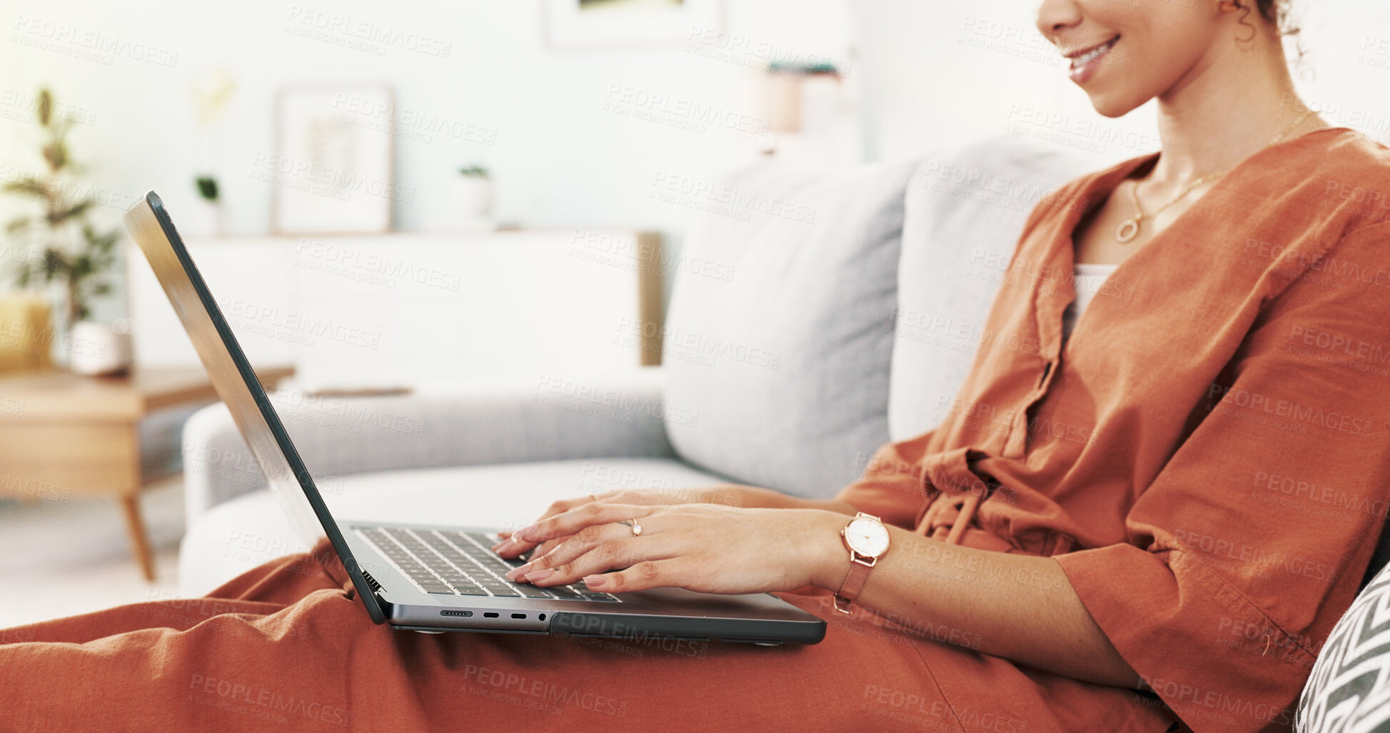 Buy stock photo Hands, laptop and typing on sofa, home and girl with smile for remote work, planning or editing for project. Woman, writer and happy with computer for story, article or review with info in apartment