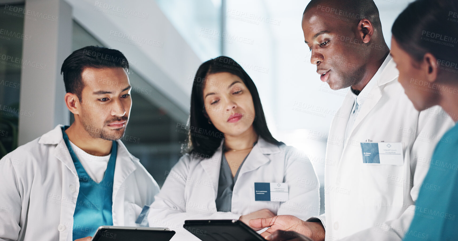 Buy stock photo Team, doctors and tablet at clinic, discussion and circle with report, results or strategy at night. People, group and diversity with digital touchscreen for review, feedback or research at hospital