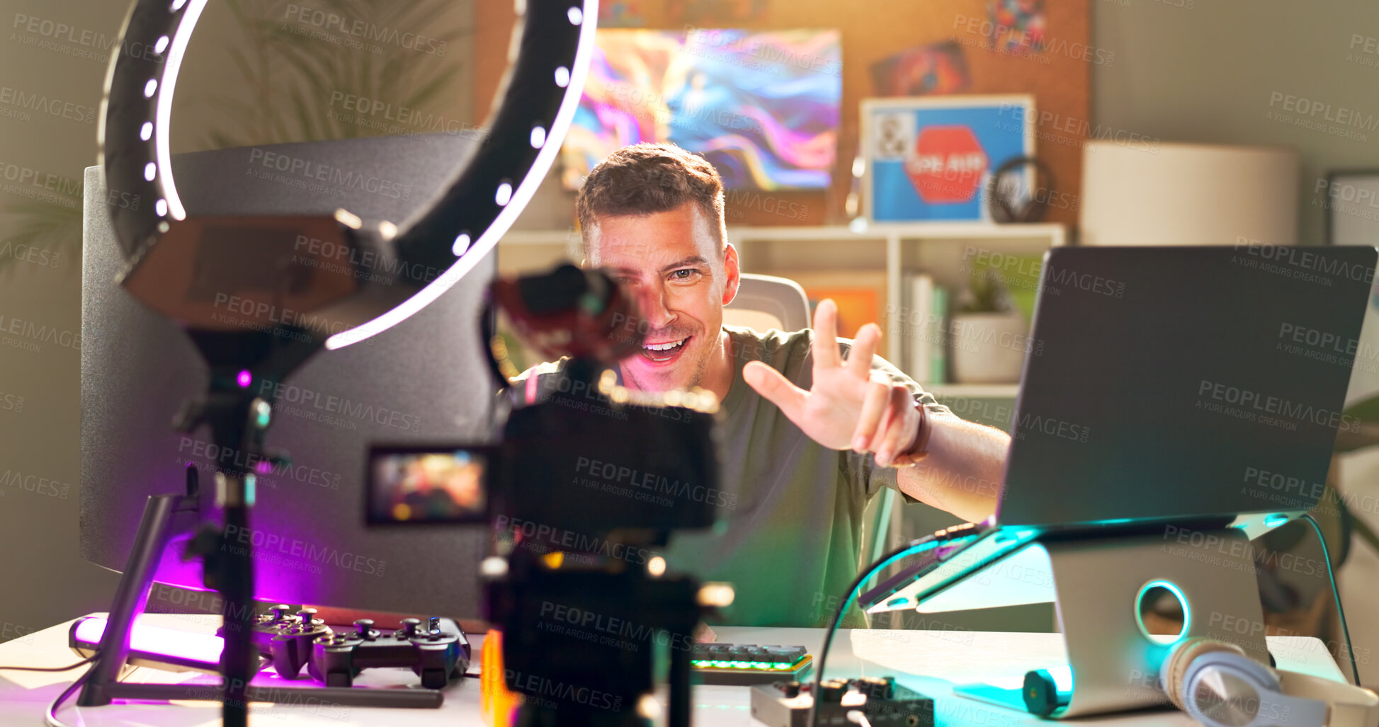 Buy stock photo Influencer, smile and wave at tech for streaming, follower interaction and content creation. Man, gamer and ring light in home for subscriber engagement, introduction and connectivity in living room