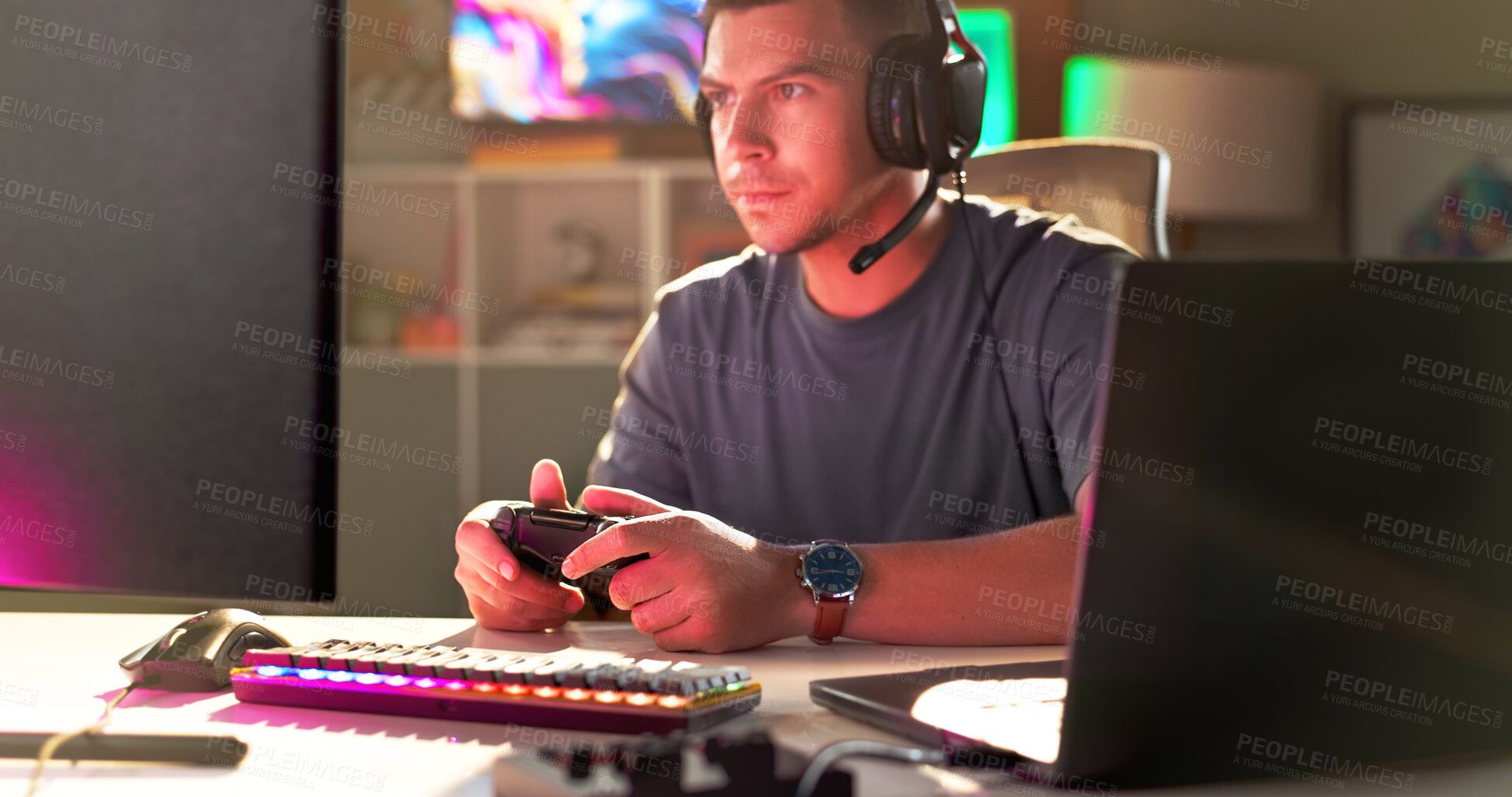 Buy stock photo Serious man, gamer and controller with headphones for esport, match or online tournament at home. Young, male person or streamer with console or computer for challenge or professional gaming at house