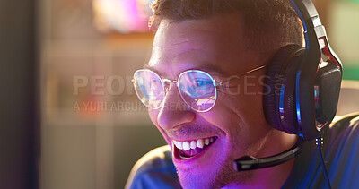 Buy stock photo Happy man, face and gamer with headphones at night for esport, online tournament or streaming at home. Young, male person or streamer with smile or headset for fun console or computer gaming at house