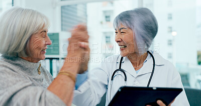 Buy stock photo Happy women, doctor and high five with tablet for good news, healthcare results or wellness at hospital. Female person, medical employee or surgeon with technology for elderly care or consultation