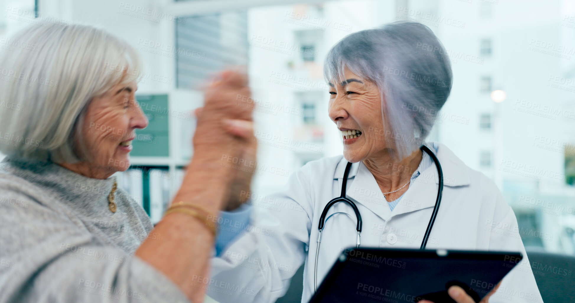 Buy stock photo Happy women, doctor and high five with tablet for good news, healthcare results or wellness at hospital. Female person, medical employee or surgeon with technology for elderly care or consultation