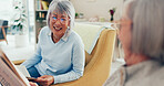 Senior women, friends and smile with newspaper at nursing home for news, gossip and entertainment. People, pensioner and happy or laughing on sofa on retirement with conversation, fun and break