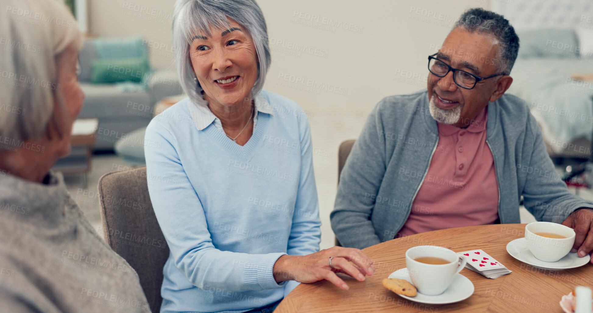 Buy stock photo Smile, tea and senior friends at table for funny conversation, snacks and retirement together in house. Happy group, party and man speaking with elderly women for breakfast, communication and bonding