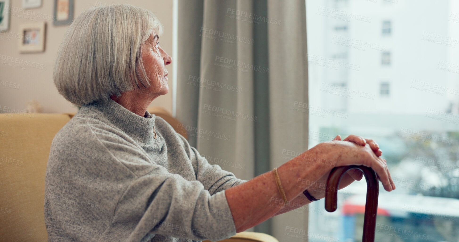 Buy stock photo Senior woman, cane and sofa for thinking in home for memory, mobility or rehabilitation by window. Retirement, walking stick and elderly person with disability, injury or reflection on couch in house