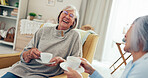 Senior women, friends and laugh with coffee at nursing home for gossip, support and bonding or love. People, pensioner and smile or happy on sofa on retirement with conversation, fun and break