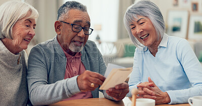 Buy stock photo Senior friends, photos and memory in home, tea party and reunion with smile, talking and bonding in retirement. Elderly man, women and discussion with group, remember and nostalgia at apartment