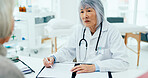 Mature woman, doctor and writing with consultation for checkup, prescription or diagnosis at hospital. Female person, surgeon or medical employee taking notes with senior clients for health insurance