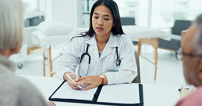 Buy stock photo Woman, doctor and writing with elderly couple for checkup, prescription or consultation at hospital. Female person, surgeon or medical employee taking notes with senior clients for health insurance