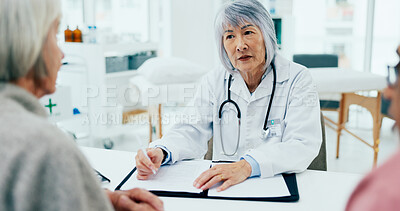 Buy stock photo Woman, doctor and writing with elderly couple for consultation, checkup or prescription at hospital. Female person, surgeon or medical employee taking notes with senior clients at healthcare clinic