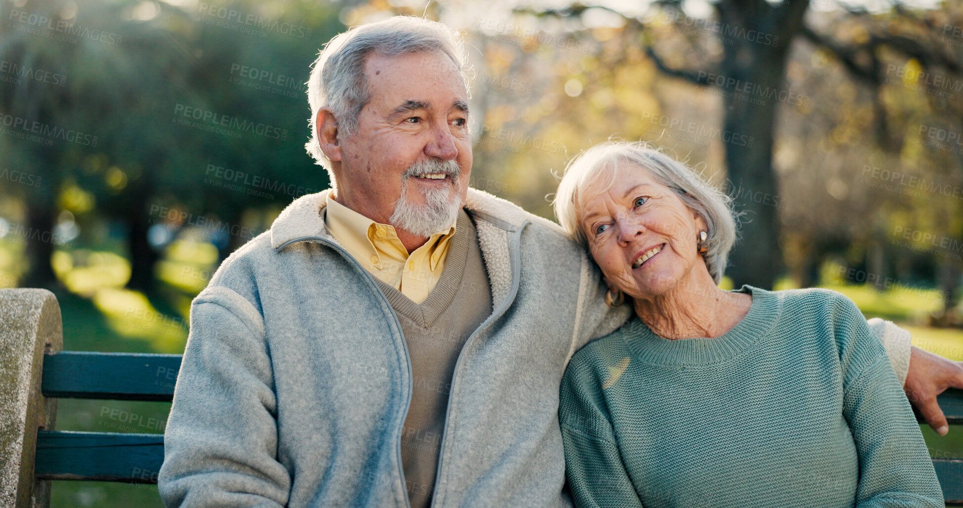 Buy stock photo Senior couple, park bench and love with hug, relax and bonding together with health. Wellness, marriage and retirement with outdoor for support and commitment on urban garden on date in nature