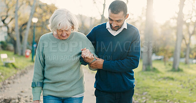 Buy stock photo Park, walking and caregiver with elderly woman for assisted living, support and care in nature. Retirement, help and man with senior person with disability outdoors for wellness, health and recovery