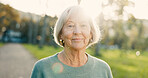 Senior, woman and smile in portrait at park for morning walk, wellness and confidence in retirement. Elderly person, face of pensioner and happy in nature for relax, lens flare and pride in street