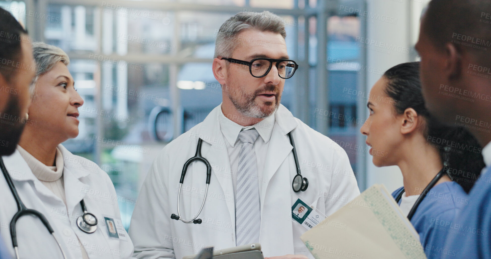 Buy stock photo Discussion, nurses and doctors in hospital with clipboard, meeting and advice for schedule in lobby. Group, men and women together in healthcare for planning, consulting and medical team in clinic