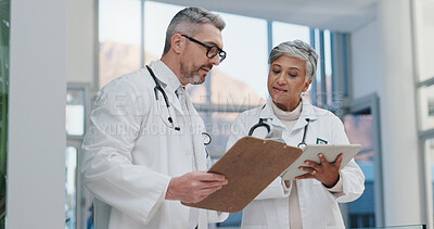 Buy stock photo Tablet, clipboard and doctors in clinic with planning, discussion and advice for schedule in lobby. Healthcare, man and woman meeting, consulting and checking digital app for medical team in hospital