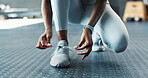 Gym, hands and woman with shoelace for fitness, exercise and workout with safety. Female person, closeup and cardio with sneaker at sports center for health, self care and wellbeing with motivation