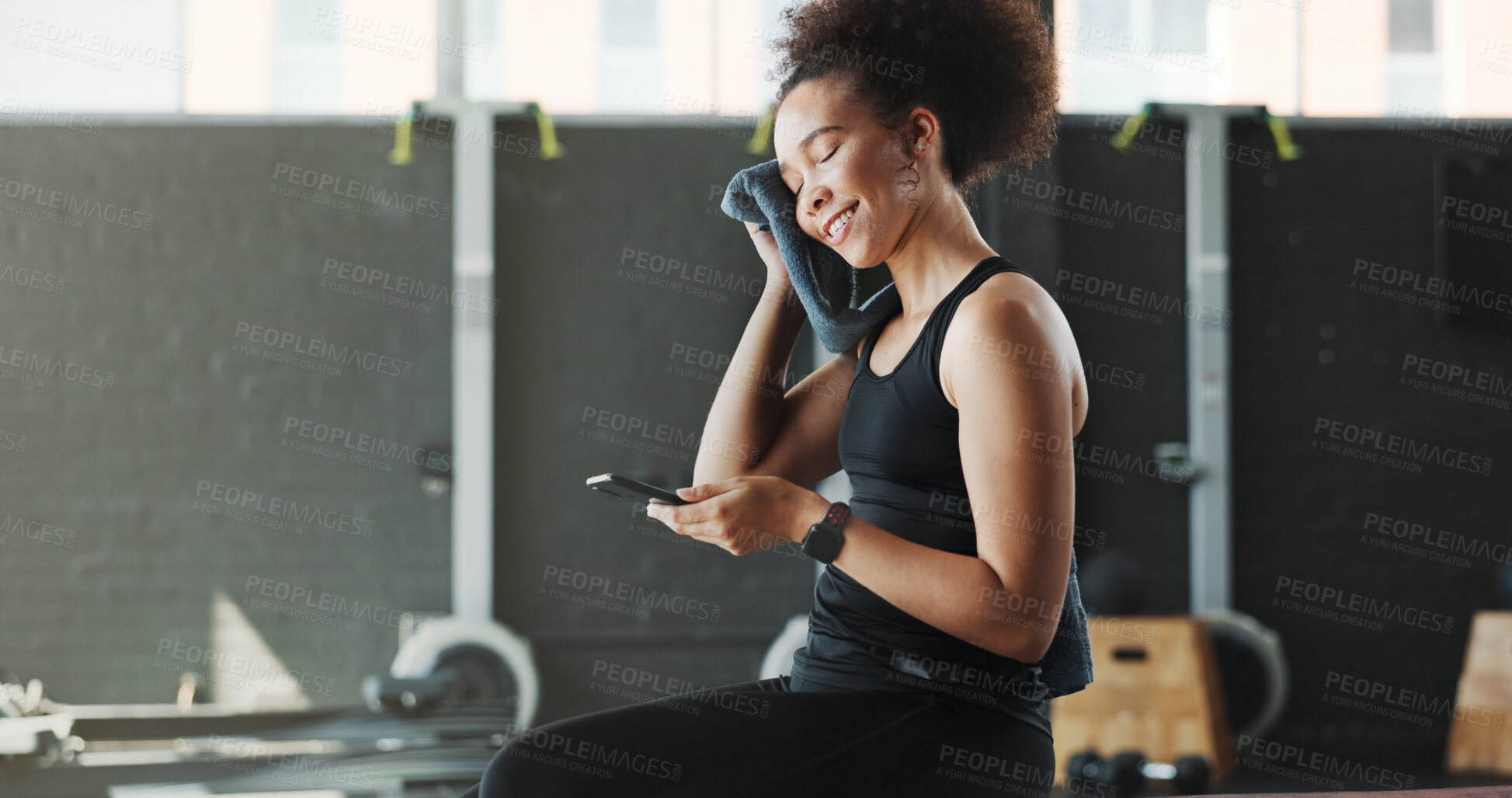 Buy stock photo Woman, gym and happy with smartphone or towel for sweat for social media post and interaction. Female person, sports center and fitness with smile or laugh on internet for funny videos and memes