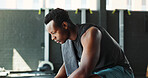 Break, fitness and thinking with black man in gym for challenge, sports training or workout. Exhausted, fatigue or towel with tired athlete person in health club for recovery or rest from exercise