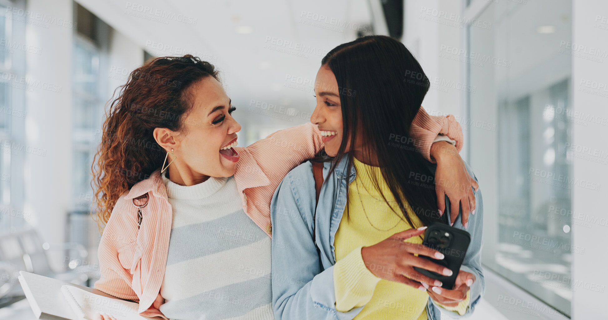 Buy stock photo Friends, happy and phone in university for gossip, storytelling and excited for personal message. Students, laughing and mobile in hallway for social media, celebrity news and secrecy in relationship