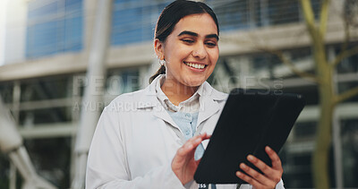 Buy stock photo Doctor, woman and happy with tablet, outdoor and reading for report, contact and app for telehealth. Person, touchscreen and medical research with click, results and feedback in hospital courtyard