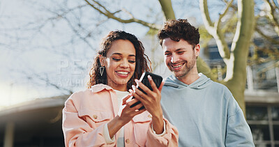 Buy stock photo Phone, smile and couple outdoor on date, travel or reading blog in city together. Mobile, happy man and interracial woman at park on app for online forum, watch video and scroll social media profile