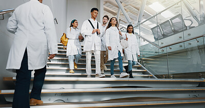 Buy stock photo University, stairs and medical students walking to class and talking, chat and conversation on campus. Diversity, healthcare college and women and men for education, learning and studying at campus