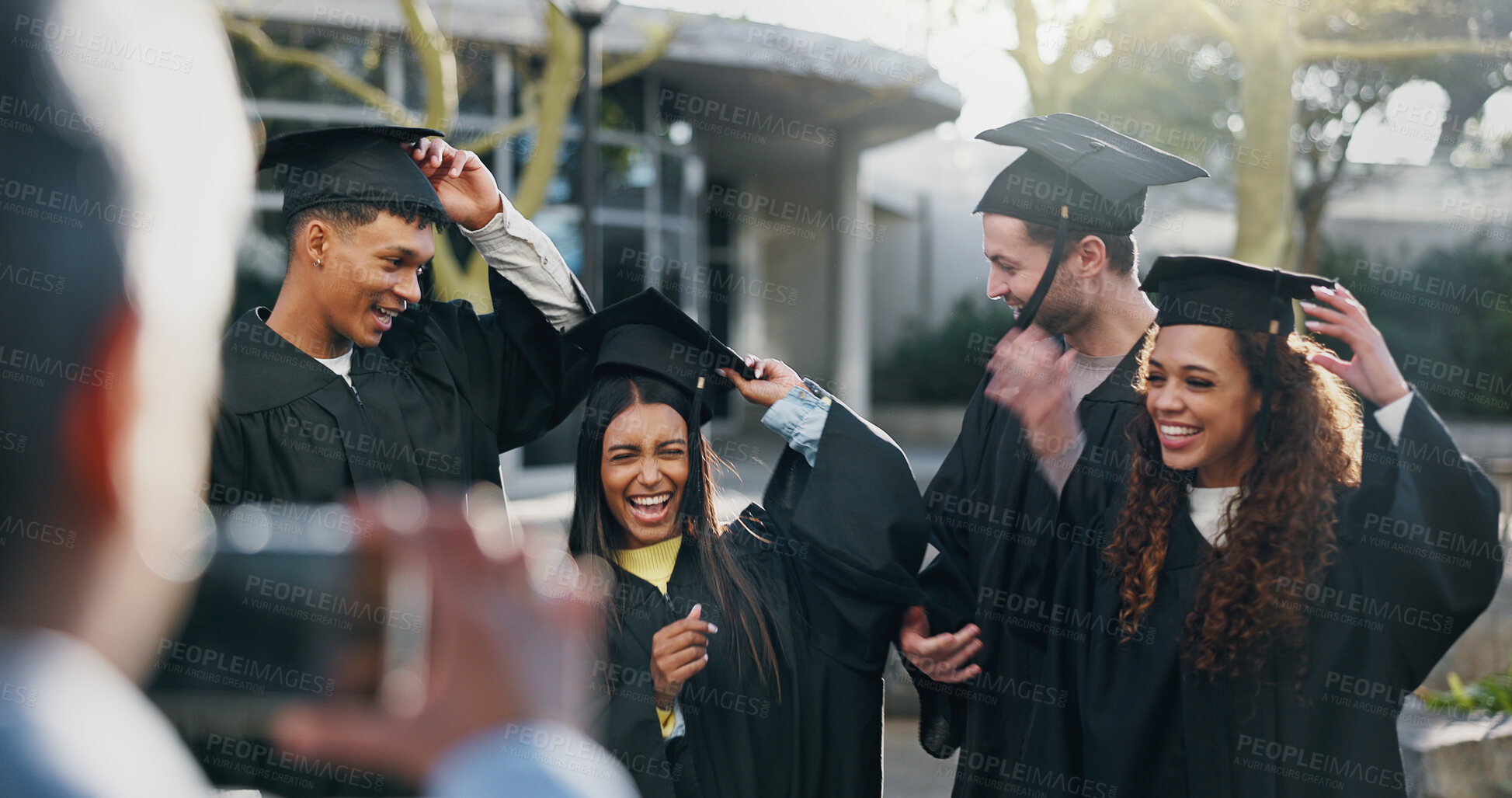 Buy stock photo Students, graduation or happy at university for photography, fun or hats for achievement. Friends, class or excited outdoors for event, academic success or taking picture for yearbook or local news