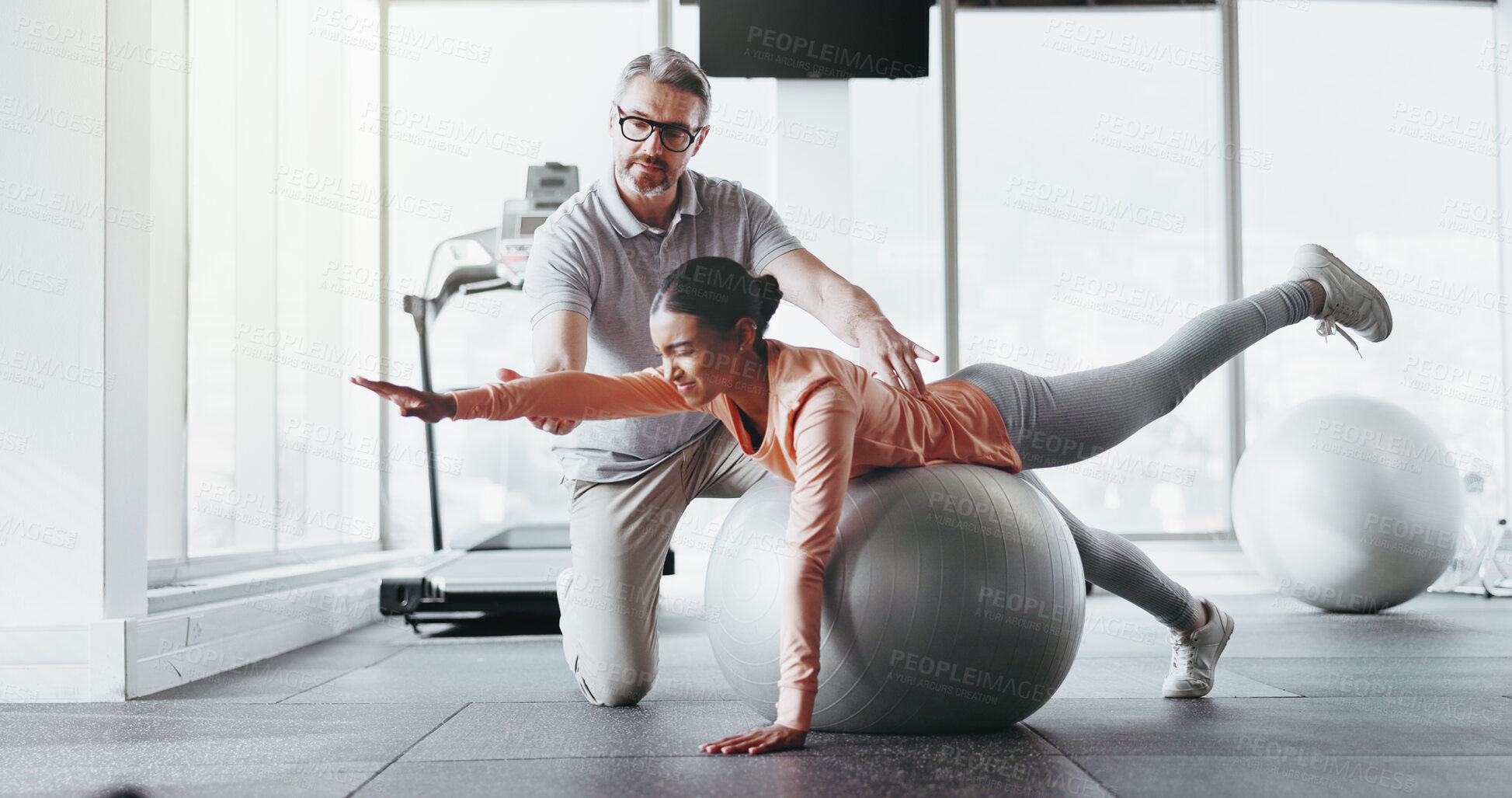 Buy stock photo Ball, girl and personal trainer in gym for fitness, rehabilitation or stability training. Man instructor, woman or physiotherapy in yoga center for core strength, pilates practice or help in exercise