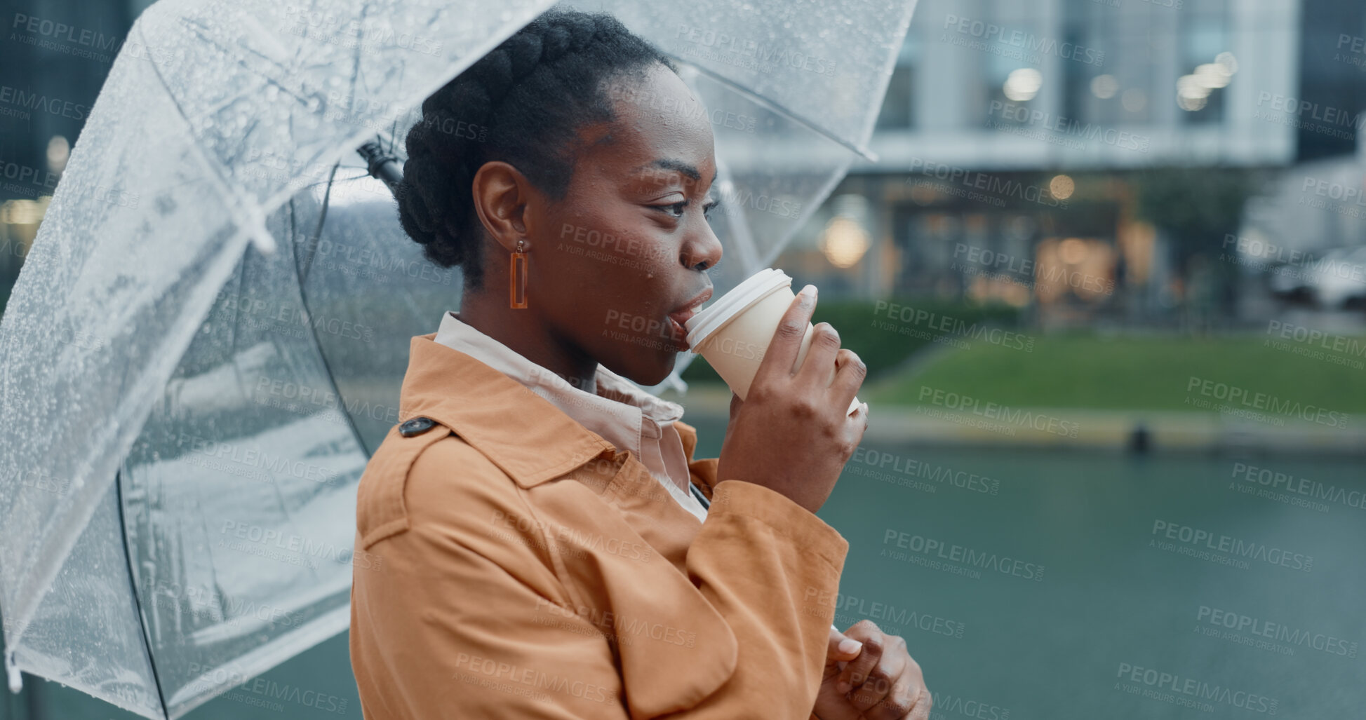 Buy stock photo Outside, black woman and smile with umbrella or coffee in rainy weather for commuting or travel to work. Female employee or professional, profile and thinking tea in city with water drops on journey