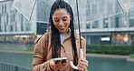 Outdoor, happy woman and umbrella with phone in city, text message and chat online on social media. Commute, female person and cellphone with rain shield for protection, water drops and track taxi