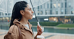 Outdoor, woman and thinking with umbrella or coffee in rainy weather for commuting or travel to work. Female person, employee or professional and profile with tea in city with water drops on journey