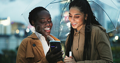 Buy stock photo City, women and umbrella with phone at night, text message and meme for online chat on social media. Outdoor, friends and rain protection with cellphone for mobile app, commute and tracking taxi