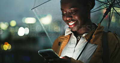 Buy stock photo Outdoor, black woman and umbrella with smartphone at night, text message and chat online on social media. City, female person and cellphone with rain shield for protection, water drops and track taxi