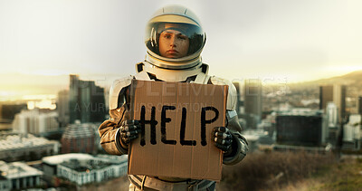 Buy stock photo Help, portrait and sign with astronaut in city, outdoor on planet earth for space exploration or sustainability. Face, helmet and poster with interstellar woman in universe for adventure or discovery