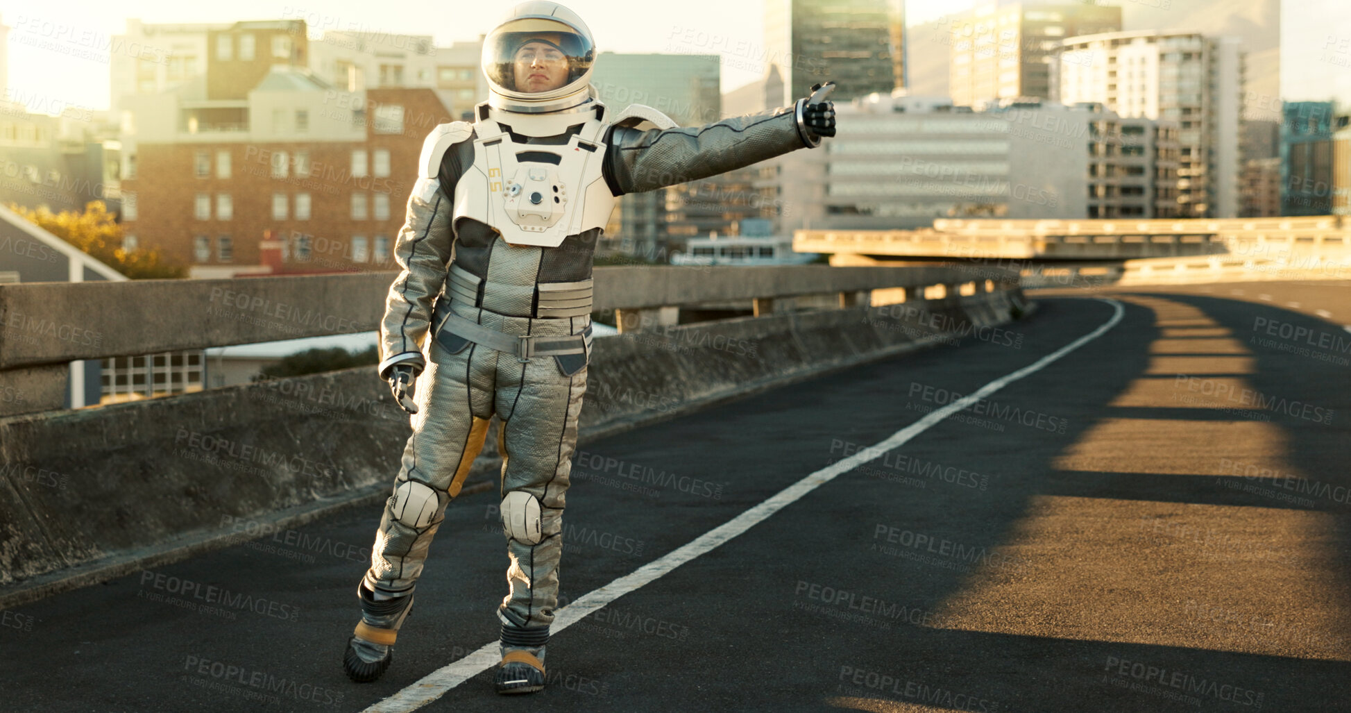 Buy stock photo Astronaut, outdoor and tourism of planet, road and suit for protection, explore or hitchhiking for mission. Travel, journey and person in city and adventure of science fiction, discovery or thumbs up