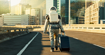 Buy stock photo Astronaut, person and suitcase in city for travel survival, planet dystopia and spacesuit of aerospace mission. Back, highway and luggage for emergency safety, sci fi journey and adventure of explore