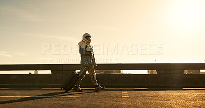 Buy stock photo Suitcase, travel and astronaut in city with future dystopia, road and planet discovery. Earth, street and person in cosplay suit on urban highway adventure for research, science and sci fi universe