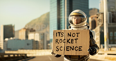 Buy stock photo Astronaut, person and message with helmet in city for dystopia awareness, cardboard and alert of planet earth. Billboard, poster and travel news for future sustainability, protest sign and mission