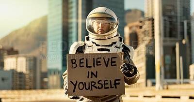 Buy stock photo Person, astronaut and outdoor with note on poster in city for career inspiration, motivation and courage. Portrait, employee and outside with card or sign board on spacesuit for proud message 