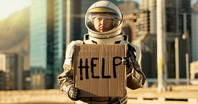 Buy stock photo Person, astronaut and outdoor with poster or help note for earth, environmental and natural resources issues. Employee, outside and sad on portrait with spacesuit and sign board for mars migration