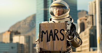 Buy stock photo Person, astronaut and billboard with helmet in city for dystopia awareness, message and alert of planet earth. Billboard, poster and travel news for future sustainability, protest sign and mission