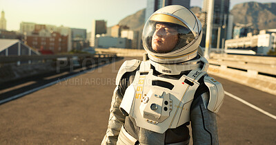 Buy stock photo Person, astronaut and outdoor in city with thinking for scientific research, mission and experiment for environment. Spacesuit, outside and sci fi with adventure, discovery and project for earth