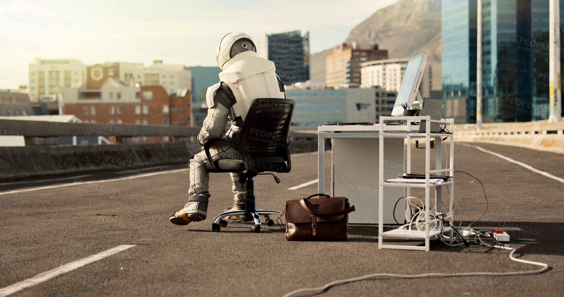 Buy stock photo Back, city and astronaut working in road for business project with interstellar report for mission. Technology, person and bored space pilot at desk with discovery of civilization on bridge in town.