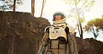 Nature, dream and astronaut thinking outdoor on planet earth for exploration, adventure or travel. Space suit, idea and interstellar person in woods for discovery, plan or brainstorming for future.