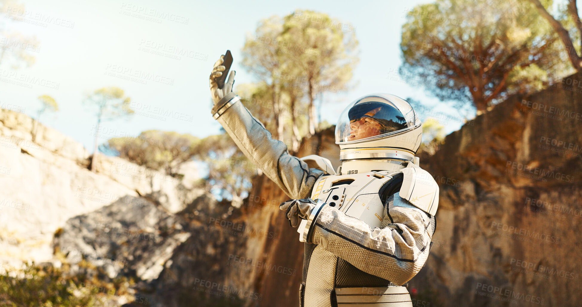 Buy stock photo Astronaut, woman and phone for lost on planet outdoor with no signal, emergency protocol and space navigation. Person, confused and emu suit with mobile for communication breakdown of mission safety