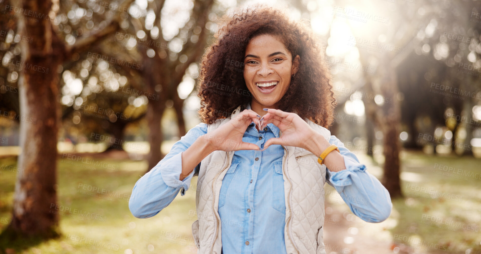 Buy stock photo Portrait, outdoor and woman with heart hands, support and nature with kindness, trust and care. Face, person and girl in park, gesture and happiness with emoji, sign and symbol for love and smile